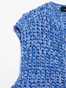 Detail of the thick knit V-pattern texture on this blue sleeveless sweater vest