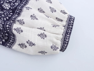 Macro detail of French floral print sleeve with elastic cuff on a long-sleeved shirt