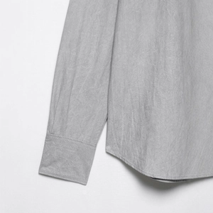 Minimalist light grey long sleeve shirt with textured fabric and curved hem detail