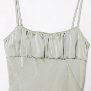 Elegant slim fit sage green satin midi dress with ruched bust and thin straps
