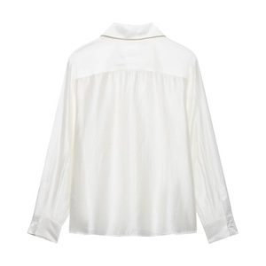 Back view of elegant white satin long sleeve blouse with pleat details and silky texture