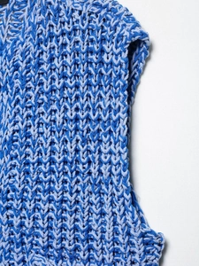 Detailed close-up of thick blue bicolored knit vest showing chunky V-stitch texture
