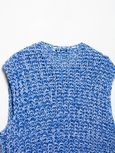 Macro shot of blue chunky knit texture and round neckline on a sleeveless vest