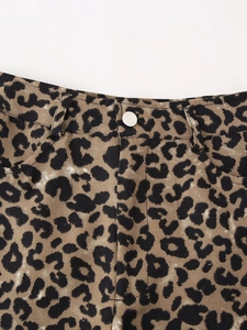 Detail of leopard print shorts featuring silver button and belt loops on waist