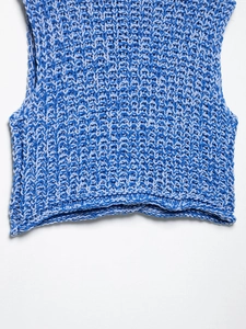 Close-up of chunky knit texture in mixed blue tones on sleeveless vest top