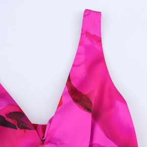 Detail showing high-quality satin fabric with vibrant floral print and V-neckline structure