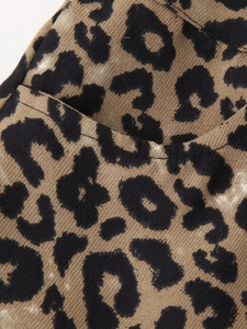 Detailed macro view of leopard print shorts showing texture and pocket stitching