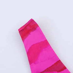 Detailed view of the hot pink backless summer dress featuring red tie-dye pattern texture
