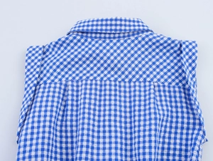 Detail of blue and white gingham sleeveless jumpsuit showing collar and shoulder yoke