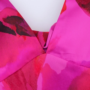 Detail of the deep V-neckline on the summer dress with vibrant pink and purple floral print