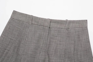 Detail shot of the houndstooth fabric texture and waist belt loops on business shorts