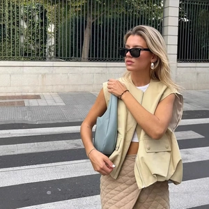 Women's beige faux leather utility vest with multiple pockets for a minimalist urban look