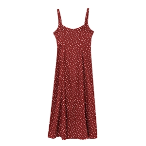 Detail of red polka dot dress featuring fine spaghetti straps and a classic U-neckline