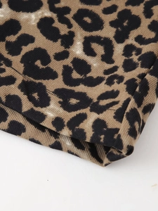 Close-up of leopard print knitted ribbed fabric showing high-quality stitching detail