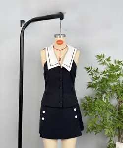 Detail of contrast color two-piece set with sleeveless vest and matching skirt