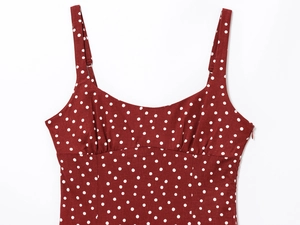 Detail of burgundy polka dot dress with adjustable straps and sweetheart pleated neckline