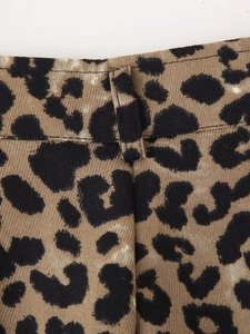 Close-up of leopard print fabric detail with twill texture and belt loop stitching