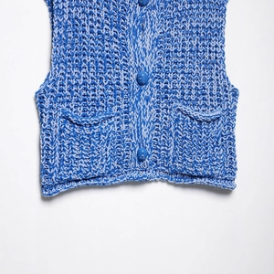Women's blue chunky knit vest with buttons and front pockets in a honeycomb pattern
