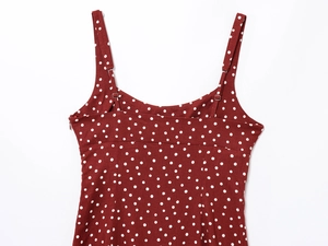 Detail of red polka dot summer dress showing adjustable thin straps and side zipper