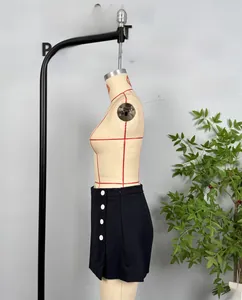 Detail view of black skirt-pants with white decorative buttons and invisible side zipper