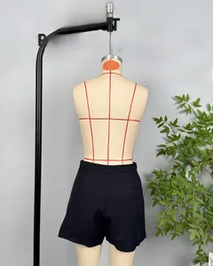 Detail view of black high-waisted casual shorts with pleated waist design on mannequin