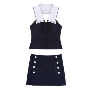 Detail of navy blue two-piece set featuring sailor collar vest and buttoned mini skirt
