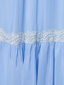 Detail of light blue chiffon fabric featuring intricate white lace trim and pleated texture