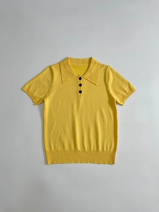 Detail of ginger yellow knitted Polo shirt showing ribbed cuffs and collar with buttons
