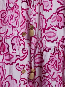 Detail of floral print dress with wooden buttons and drawstring with wooden pendants