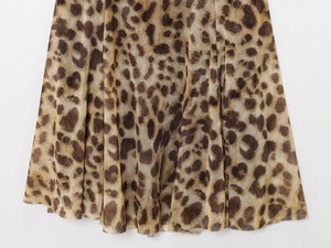 Close-up of leopard print dress fabric showing soft draping and texture details