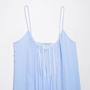Light blue summer camisole dress with white lace trim and pleated fabric texture