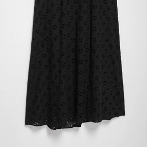 Women's black halter neck dress with intricate hollow embroidery and lace details