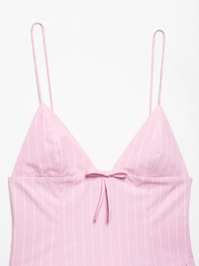 Detail of pink and white striped camisole top featuring a delicate V-neck and front bow tie