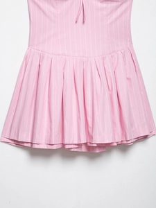 Detail of pink striped dress showing pleated hem and delicate fabric texture