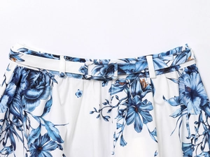 Detail of floral midi skirt waist with matching fabric-covered buckle belt and blue print