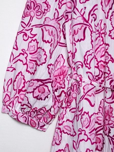 Close-up of floral print summer dress with ruffled sleeves and adjustable waist tie