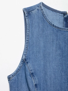 Detail of blue denim dress featuring contrast stitching and hidden zipper at the neckline
