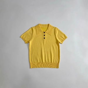 Women's bright yellow short sleeve knit polo shirt with stylish black buttons