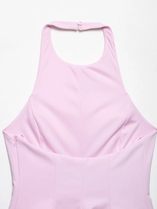 Detail of pink halter top showing button closure at neck and side invisible zipper