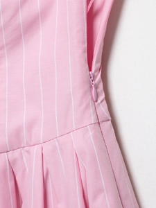 Close-up of pink striped dress showing fine pleats and high-quality invisible side zipper