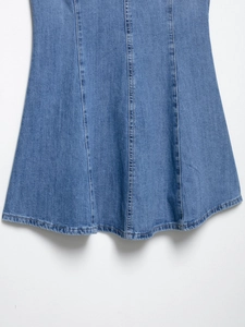 Detail of light blue denim dress hem with vertical stitching and smooth double-needle edge