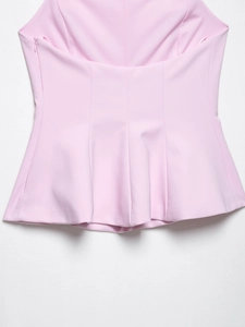 Detail of pink halter top showing peplum hem with vertical seams and side zipper