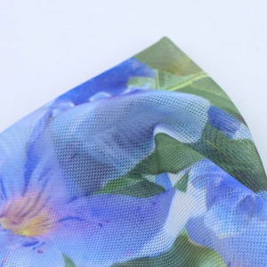 Detail of French vintage floral print on lightweight mesh fabric with blue and purple tones