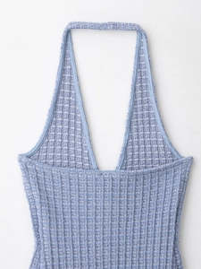Vue détaillée du haut dos nu en maille bleu clair avec décolleté en V profond et tissu côtelé