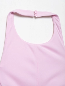 Detail view of the pink halter neck top showing neckline texture and double button closure