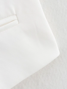 Detail shot of white twill fabric showing the precise stitching and welt pocket design