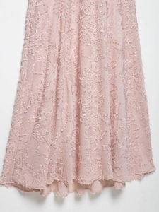 Detail of pink shaggy textured jacquard fabric with soft feather-like fringe and inner lining