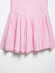 Detail of pink and white vertical stripes on pleated dress with fine fabric texture