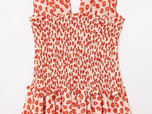 Detail of floral mini dress with smocked elastic waist and red flower pattern on beige fabric