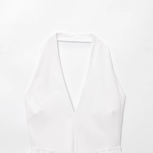 Summer white halter neck deep V-neck balloon top with pleated details in woven fabric